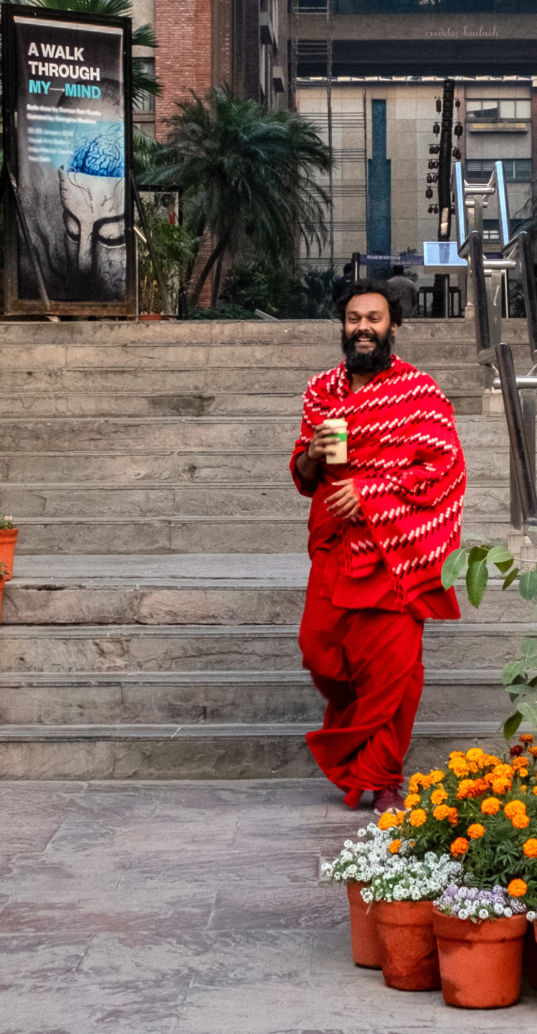 Pavan in robes; walking with a lassi in his hand